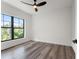 Well-lit bedroom featuring dark grey vinyl flooring and a large window at 321 W Hanlon St, Tampa, FL 33604