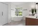 Modern bathroom with freestanding soaking tub and double vanity at 321 W Hanlon St, Tampa, FL 33604