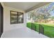Inviting covered back porch overlooking a lush, well-maintained lawn and fenced yard at 2206 N Boulevard, Tampa, FL 33602