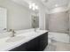 Modern bathroom with double sinks, quartz countertops, tile floors, and a shower-tub combination at 2206 N Boulevard, Tampa, FL 33602