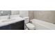 Clean and modern bathroom features a dark vanity, light countertop, and a tiled shower-tub combo at 2206 N Boulevard, Tampa, FL 33602