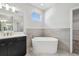 Stylish bathroom featuring standalone tub, modern vanity and tile flooring at 2206 N Boulevard, Tampa, FL 33602