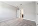 Minimalist bedroom with ensuite bathroom and light gray carpet, creating a calm and inviting atmosphere at 2206 N Boulevard, Tampa, FL 33602