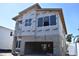 Two-story home's exterior shows a work in progress with windows and a two car garage on a sunny day at 2206 N Boulevard, Tampa, FL 33602