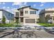 Modern two-story home featuring a small balcony, beautiful landscaping, and an attached two-car garage at 2206 N Boulevard, Tampa, FL 33602