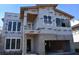 Two-story home's exterior shows a work in progress with windows and a two car garage on a sunny day at 2206 N Boulevard, Tampa, FL 33602