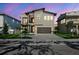 Modern two-story home featuring a small balcony, beautiful landscaping, and an attached two-car garage at 2206 N Boulevard, Tampa, FL 33602