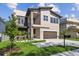 Modern two-story home featuring a small balcony, beautiful landscaping, and an attached two-car garage at 2206 N Boulevard, Tampa, FL 33602