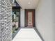 Close up of the modern front door with brick and gray wood accent panels at 2206 N Boulevard, Tampa, FL 33602
