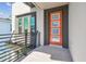 Contemporary home featuring an orange front door with glass panels and a modern railing on the adjacent balcony at 2206 N Boulevard, Tampa, FL 33602