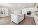 Open kitchen featuring a large island, stainless steel appliances, quartz countertops, and hardwood floors at 2206 N Boulevard, Tampa, FL 33602
