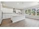 Bright open-concept kitchen with large windows, modern cabinets, stainless steel appliances, and hardwood floors at 2206 N Boulevard, Tampa, FL 33602