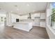 Spacious kitchen featuring a large island, modern stainless steel appliances, and light-colored hardwood floors at 2206 N Boulevard, Tampa, FL 33602