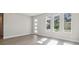Bright living room with wood-look flooring, white walls, and modern front door and windows at 2206 N Boulevard, Tampa, FL 33602