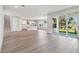 Spacious open-concept living area with hardwood floors, a modern kitchen, and sliding glass doors to the backyard at 2206 N Boulevard, Tampa, FL 33602