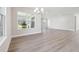 Open living room with hardwood floors, neutral walls and large windows overlooking the yard at 2206 N Boulevard, Tampa, FL 33602