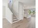 Open-concept space featuring modern staircase and view of kitchen at 2206 N Boulevard, Tampa, FL 33602
