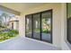 Covered patio with large sliding glass doors, and view of the backyard at 2206 N Boulevard, Tampa, FL 33602