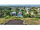 Aerial view of waterfront homes with pools and lush landscaping near the marsh at 4031 Eagle Nest Dr, Hernando Beach, FL 34607