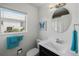 Bright bathroom with a modern sink, mirror, and a window providing natural light to the space at 4031 Eagle Nest Dr, Hernando Beach, FL 34607