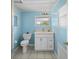 Bright bathroom boasts a white vanity with marble countertop and a toilet at 4031 Eagle Nest Dr, Hernando Beach, FL 34607