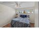 Cozy bedroom features a ceiling fan, window with blinds and patterned flooring at 4031 Eagle Nest Dr, Hernando Beach, FL 34607