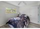 Well-lit bedroom with a floral patterned comforter, large window, and hardwood floors, offering a tranquil space at 4031 Eagle Nest Dr, Hernando Beach, FL 34607