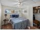 Cozy bedroom features a ceiling fan, window with blinds and an open closet at 4031 Eagle Nest Dr, Hernando Beach, FL 34607