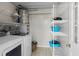 Efficient laundry room with washer, dryer, and shelving for storage at 4031 Eagle Nest Dr, Hernando Beach, FL 34607