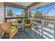 Relaxing screened-in patio with comfortable seating and views of the surrounding landscape and blue skies at 4031 Eagle Nest Dr, Hernando Beach, FL 34607