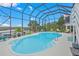 Enclosed pool area with comfortable seating and views of the open water offering the perfect outdoor getaway at 4031 Eagle Nest Dr, Hernando Beach, FL 34607