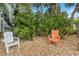 Backyard with gravel, palm trees and chair at 4031 Eagle Nest Dr, Hernando Beach, FL 34607