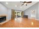 Living room with hardwood floors, fireplace, and access to a screened patio at 15019 Southfork Dr, Tampa, FL 33624
