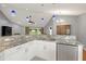 Modern kitchen with white cabinets, granite countertops, and stainless steel appliances at 15019 Southfork Dr, Tampa, FL 33624