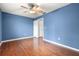 Bedroom with ceiling fan, wood flooring and access to bathroom at 15019 Southfork Dr, Tampa, FL 33624