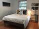 Comfortable bedroom with hardwood floors and bedside table at 1411 E Powhatan Ave, Tampa, FL 33604