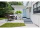Private backyard with patio furniture and access to unit at 1411 E Powhatan Ave, Tampa, FL 33604