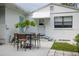 Small patio area with table and chairs, next to the house at 1411 E Powhatan Ave, Tampa, FL 33604