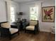 Cozy living room with two armchairs and hardwood floors at 1411 E Powhatan Ave, Tampa, FL 33604
