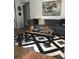 Living room with sectional sofa and a large area rug at 1411 E Powhatan Ave, Tampa, FL 33604