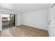 Bedroom with laminate flooring and sliding glass door to balcony at 9009 Westchester Cir # B-18, Tampa, FL 33604