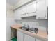 Kitchen with white cabinets, double sink, and ample counter space at 9009 Westchester Cir # B-18, Tampa, FL 33604