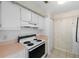 Kitchen with white cabinets and a four-burner stove at 9009 Westchester Cir # B-18, Tampa, FL 33604