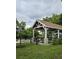 Wooden gazebo with brown roof and wooden railing at 6404 Land O Lakes Blvd., Land O Lakes, FL 34638