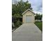 Detached storage shed with roll-up door and concrete pad at 6404 Land O Lakes Blvd., Land O Lakes, FL 34638