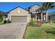 Two-story house with a two-car garage and manicured lawn at 8615 Savory Walk Dr, Land O Lakes, FL 34637