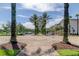 Brick pathway lined with palm trees leading to a community area at 14175 Stilton St, Tampa, FL 33626