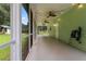 Long screened porch with string lights and ceiling fan at 15050 Appaloosa Hills Dr, Dade City, FL 33523