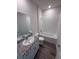 Bathroom features a shower-tub combo, granite countertops, and a large mirror at 18146 Beach Ranch Ter, Lakewood Ranch, FL 34211