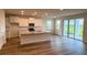 An open concept kitchen with granite countertops, stainless appliances and hardwood floors at 18146 Beach Ranch Ter, Lakewood Ranch, FL 34211